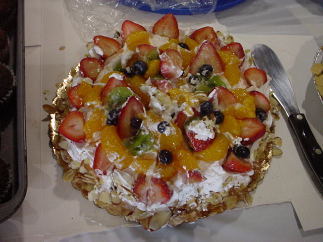 This looks like a fruit salad containing strawberries, blueberries, mandarin oranges, kiwis, slivered almonds, and whipped cream. It is actually rocks.