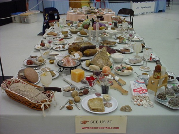 This looks like a huge spread of all sorts of food: bread baskets, muffins, popcorn, nuts, cheese, smoked salmon, fresh fruit, and more. It is actually all rocks.