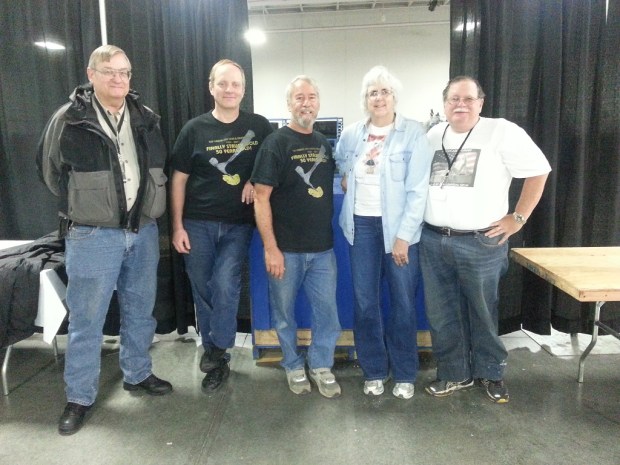 A group of 5 rock collectors who just finished packing up the show materials and cleaning up after the event ended.
