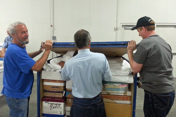 Show-Me Rockhounds members loading the storage container. 