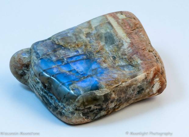 Polished moonstone fragment several centimeters long showing the moonstone effect.