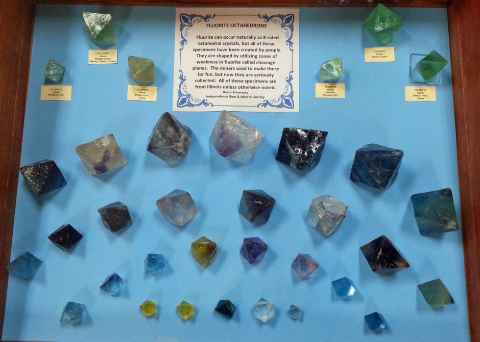 A display of fluorite octahedrons of many different colors and sizes.